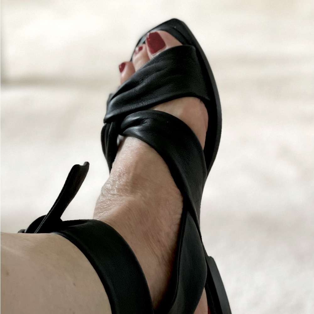 Black leather sandals.
